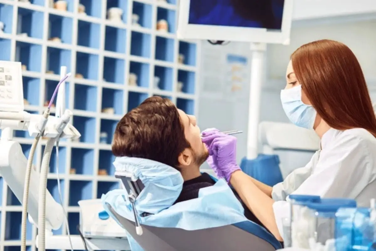 Patient receiving same day dental crown treatment at the dentist's office with modern technology