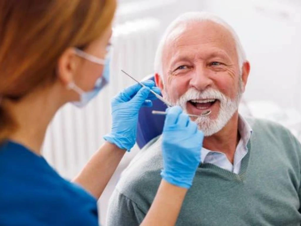 Senior patient receiving gentle dental care, emphasizing the importance of oral health for aging individuals