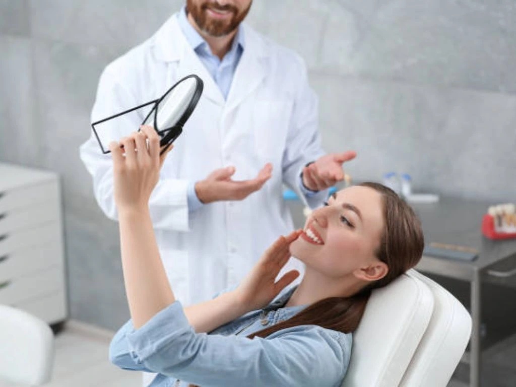 Patient checking her smile after same day dental crown treatment