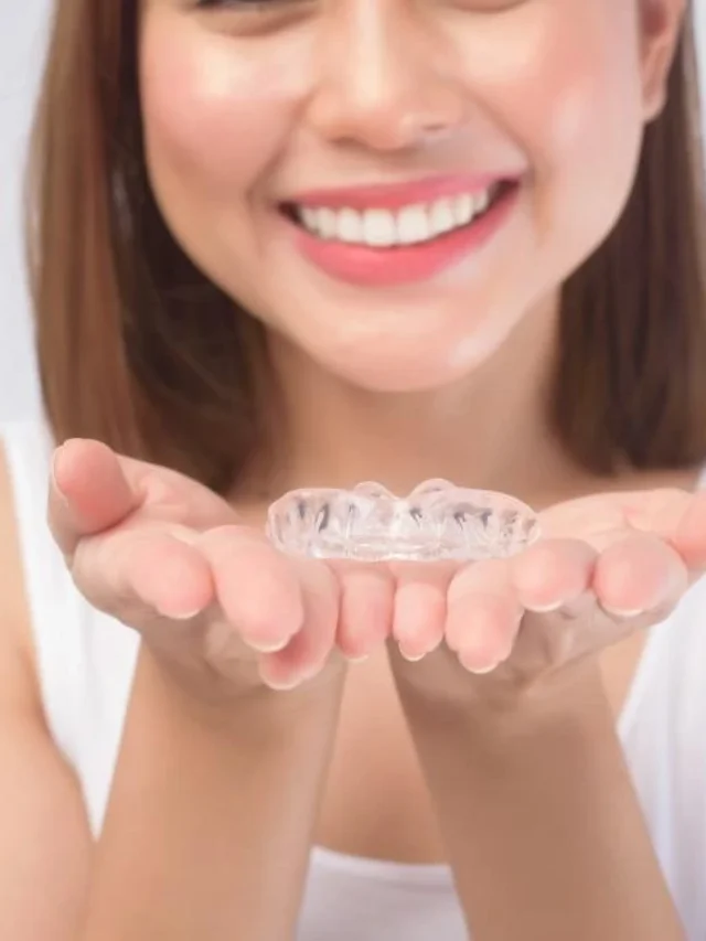 woman-holding-clear-plastic-invisible-braces-in-open-hands